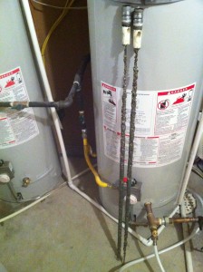 Integrated anode connected to hot water outlet