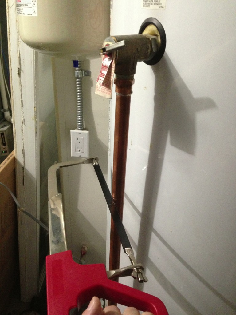 Cutting away the old drain pipe tubing