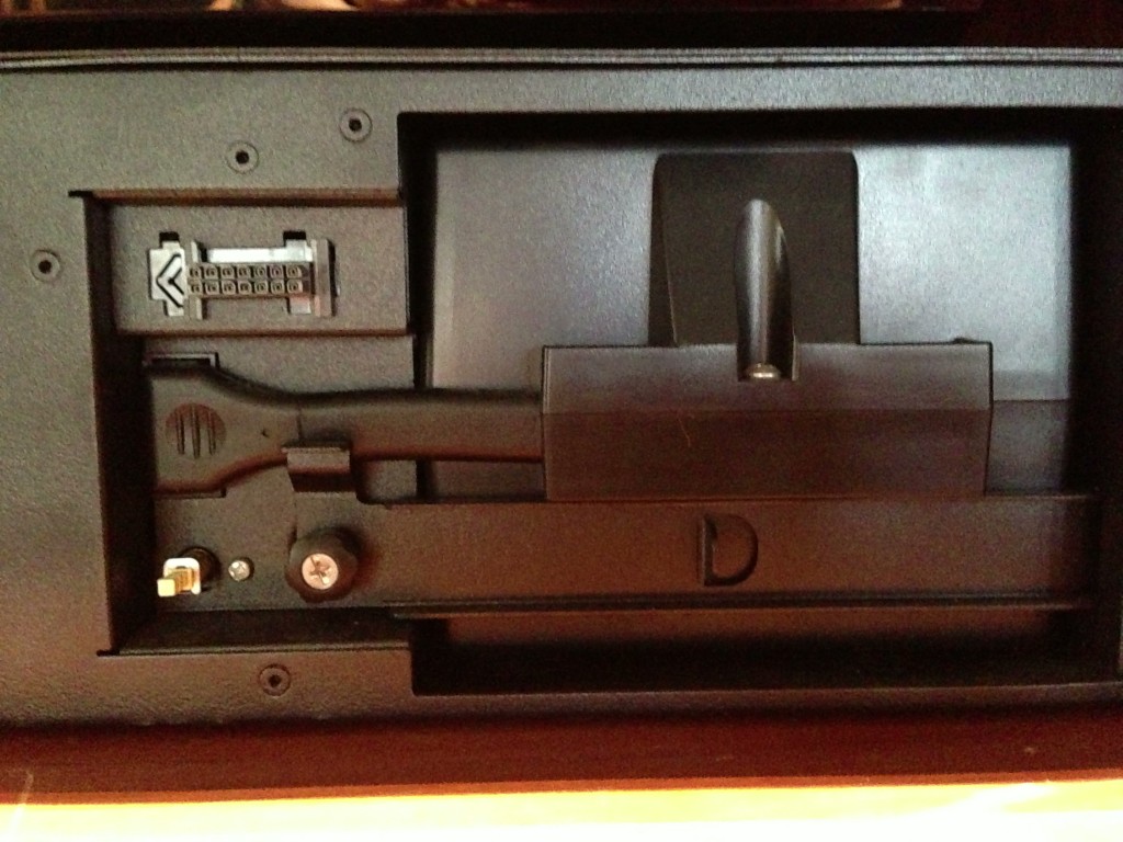 Remove the front bezel from the unit, and unscrew the metal battery retainer.