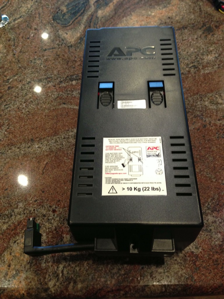 Place the battery pack on a flat surface, remove all three external screws, and remove the cover.