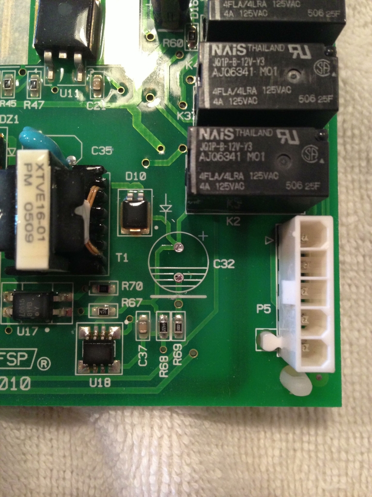 Old capacitor removed from location C32